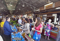 France, Provence-Alps, Cote d'Azur, Antibes, Provencal food market busy with tourists and locals buying fresh fruit and vegetables.