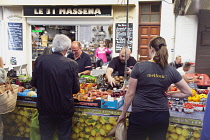 France, Provence-Alps, Cote d'Azur, Antibes, Provencal food market busy with tourists and locals buying fresh fruit and vegetables.