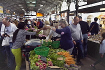 France, Provence-Alps, Cote d'Azur, Antibes, Provencal food market busy with tourists and locals buying fresh fruit and vegetables.