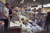 France, Provence-Alps, Cote d'Azur, Antibes, Provencal food market busy with tourists and locals buying cheese.