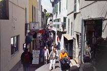 France, Provence-Alps, Cote d'Azur, Antibes, Side street leading to the Provencal Food market busy with shoppers.