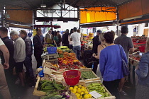 France, Provence-Alps, Cote d'Azur, Antibes, Provencal food market busy with tourists and locals buying fresh fruit and vegetables.