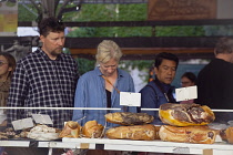 France, Provence-Alps, Cote d'Azur, Antibes, Provencal food market busy with tourists and locals buying dried and cured meats.