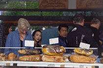 France, Provence-Alps, Cote d'Azur, Antibes, Provencal food market busy with tourists and locals buying dried and cured meats.