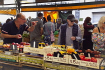 France, Provence-Alps, Cote d'Azur, Antibes, Provencal food market busy with tourists and locals buying fresh fruit and vegetables.