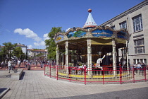 France, Provence-Alps, Cote d'Azur, Antibes, Carousel next to childrens play area on Rue de la Republique.