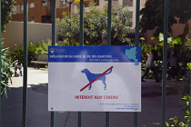 France, Provence-Alps, Cote d'Azur, Antibes, No dogs allowed sign on childrens play park.
