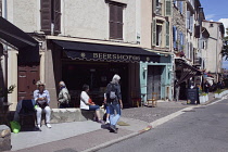 France, Provence-Alps, Cote d'Azur, Antibes, Tourists sat outside cafe bar in the old town.