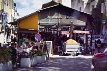 France, Provence-Alps, Cote d'Azur, Antibes, Cooking Socca an nicoise chickpea pancake in the Provencal food market.