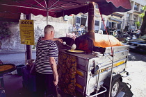 France, Provence-Alps, Cote d'Azur, Antibes, Cooking Socca an nicoise chickpea pancake in the Provencal food market.