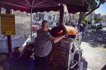 France, Provence-Alps, Cote d'Azur, Antibes, Cooking Socca an nicoise chickpea pancake in the Provencal food market.