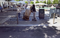 France, Provence-Alps, Cote d'Azur, Antibes, Rubbish being put into underground bins.