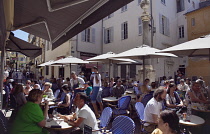 France, Provence-Alps, Cote d'Azur, Antibes, Tourists sat outside cafes and bars in the old town.