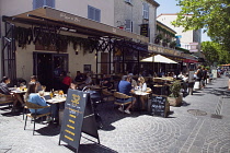 France, Provence-Alps, Cote d'Azur, Antibes, Tourists sat outside cafes and bars in the old town.