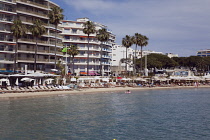 France, Provence-Alps, Cote d'Azur, Antibes Juan-les-Pins, Beach with tourists sunbathing and swimming in the sea.