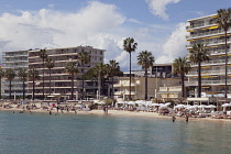 France, Provence-Alps, Cote d'Azur, Antibes Juan-les-Pins, Beach with tourists sunbathing and swimming in the sea.