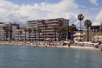 France, Provence-Alps, Cote d'Azur, Antibes Juan-les-Pins, Beach with tourists sunbathing and swimming in the sea.