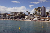 France, Provence-Alps, Cote d'Azur, Antibes Juan-les-Pins, Beach with tourists sunbathing and swimming in the sea.