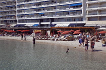 France, Provence-Alps, Cote d'Azur, Antibes Juan-les-Pins, Beach with tourists sunbathing and swimming in the sea.