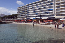 France, Provence-Alps, Cote d'Azur, Antibes Juan-les-Pins, Beach with tourists sunbathing and swimming in the sea.