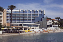 France, Provence-Alps, Cote d'Azur, Antibes Juan-les-Pins, Beach with tourists sunbathing and swimming in the sea.