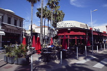 France, Provence-Alps, Cote d'Azur, Antibes Juan-les-Pins, People sat outside cafe bar eating and drinking.