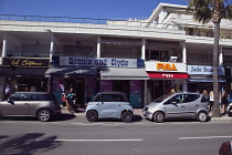 France, Provence-Alps, Cote d'Azur, Antibes Juan-les-Pins, Tourist shops with Citroen Ami electric car parked outside.