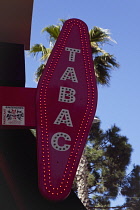 France, Provence-Alps, Cote d'Azur, Antibes Juan-les-Pins, Red illuminated Tabac sign.