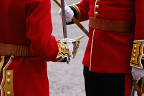England, London, The Mall, Close up of Grenadier Guardsmen swords, gloves and tunics duing the coronation of King Charles III on a rainy May 6th 2023.