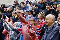 England, London, The Mall,  people celebrating the coronation of King Charles III on a rainy May 6th 2023.