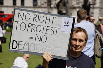 England, London, Westminster, Parliament Square, Protester holding self made placard for the Right to Protest & Democracy.
