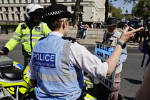 England, London, Westminster, Protesters marching outside Downing Street, Police Liaison officers engaging with a religious protestors.
