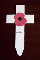 England, Wooden cross and red poppy in remembrance of military people who died during the world wars.