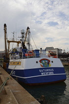 England, Hampshire, Portsmouth, Irish fishing boat in harbour with Pog Mo Thoin and Leprechaun painted above name.