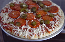 Food, Cooked,  Pizza, Frozen pepperoni and jalapeno pizza on metal tray ready to be cooked.