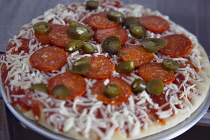 Food, Cooked,  Pizza, Frozen pepperoni and jalapeno pizza on metal tray ready to be cooked.