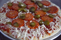 Food, Cooked,  Pizza, Frozen pepperoni and jalapeno pizza on metal tray ready to be cooked.