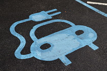 Transport, Road, Car, Blue sign painted on parking bay for electric car charging point.