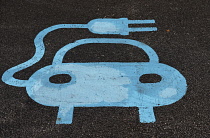 Transport, Road, Car, Blue sign painted on parking bay for electric car charging point.