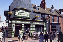 England, East Sussex, Brighton, Victory Inn public house on Duke Street and Middle Street junction with people sat outside drinking.