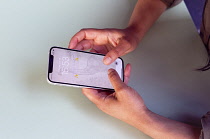 Communications, Telephone, Mobile, Woman using Apple iPhone Apps.