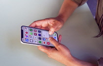 Communications, Telephone, Mobile, Woman using Apple iPhone Apps.