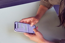 Communications, Telephone, Mobile, Woman using Apple iPhone Apps.