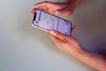 Communications, Telephone, Mobile, Woman using Apple iPhone Apps.