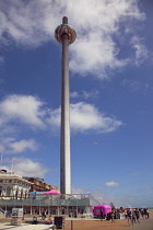 England, East Sussex, Brighton, Steel i360 observation tower on seafront promenade busy with summer tourists.