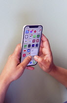 Communications, Telephone, Mobile, Woman using Apple iPhone Apps.