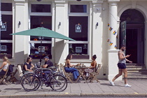 England, East Sussex, Brighton, Hove, Western Road, People sat outside T@Hove cafe.