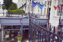 England, East Sussex, Brighton, Hove, Western Road, Entrance to Gwydr underground barber shop decorated with mutli coloured pants.