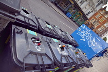 England, East Sussex, Brighton, Hove, Western Road, Bins full with bottles on the pavement.