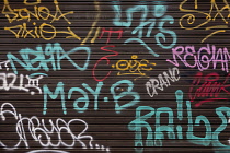 Spain, Balearic Islands, Majorca, Palma de Mallorca, colourful spray can graffiti on shop shutters.